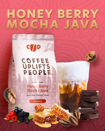 Honey Berry Mocha Java coffee bag and an iced coffee, surrounded by berries, dark chocolate, and honey to illustrate its flavor notes.