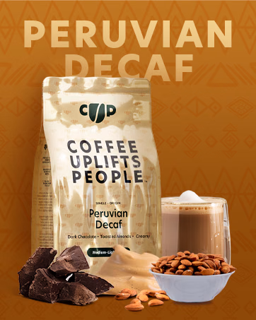 Peruvian Decaf coffee bag and a creamy coffee, with dark chocolate and toasted almonds illustrating the flavor notes.