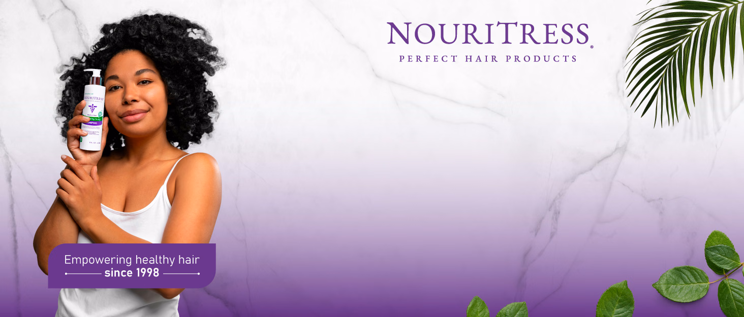 NouriTress presents a woman holding its shampoo and the message “Empowering healthy hair since 1998,” against marble, purple shading, and green leaves.